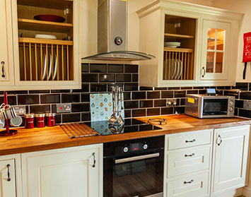 Culla Cottage Kitchen contains an oven Microwave Washing Machine Fridge Freezer Kettle and Toaster